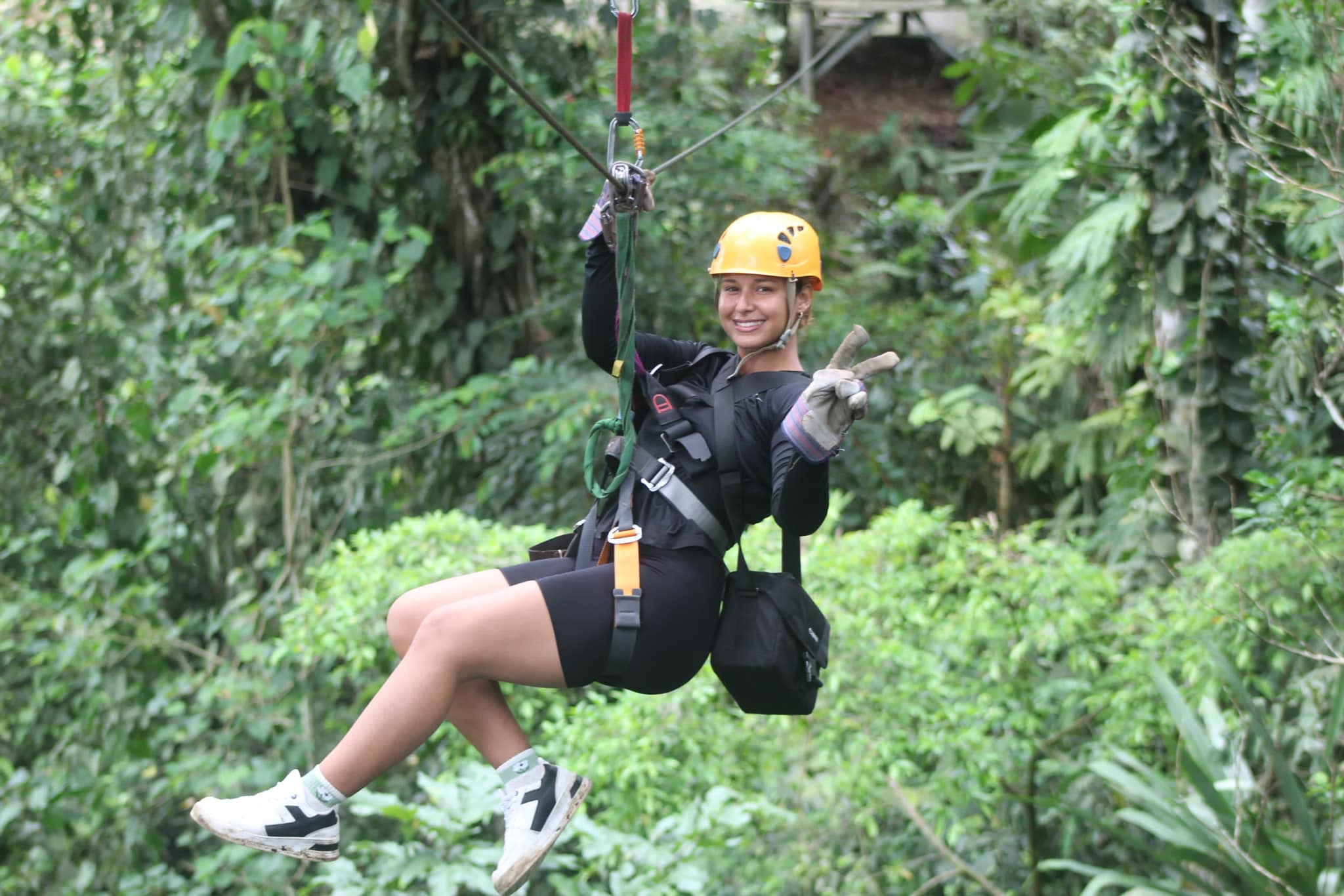 Woman smiling on zip line over Costa Rica jungle